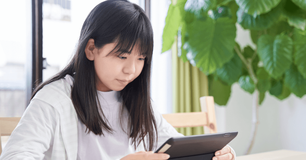 a junior high school student studying on a tablet